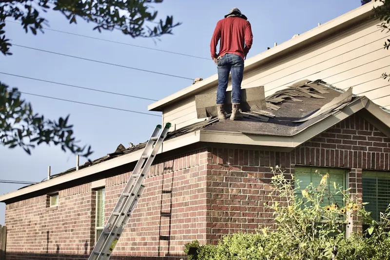 Professional roofer working on a residential roof in Thomas Lake